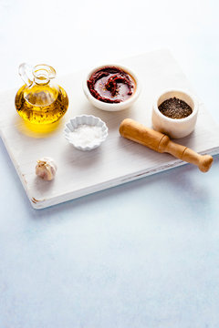 Various seasonings on a white wooden board