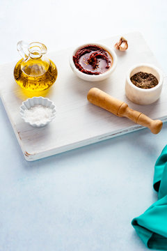 Seasonings and curry paste on a white wooden board