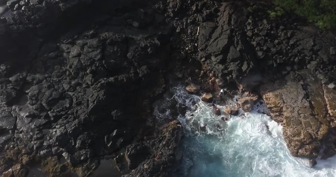 Aerial/Drone - Man Picks Opihi Traditional Way on Lava Coast (Puna - Big Island, Hawaii)