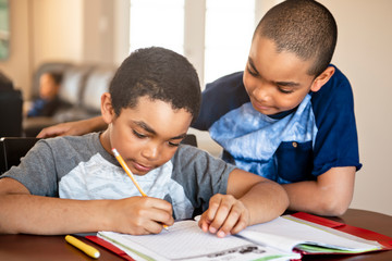 two black brother child doing homework at home