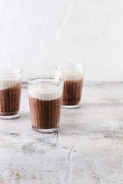 Three caffe mochas on concrete surface