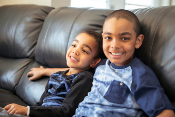Cute happy african american sit on the livingroom at home