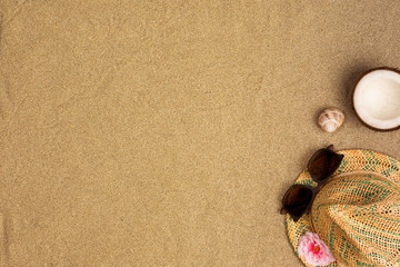 Fototapeta na wymiar Frame of straw hat, sunglasses, seashells. Traveler accessories on sand. Travel vacation concept. Summer background
