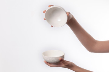 Porcelain dish bowl in hand isolated on white background