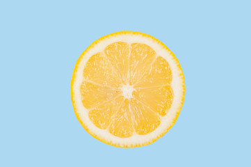 Lemon slice on pastel blue background