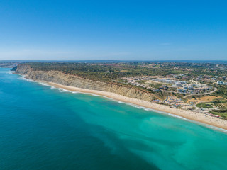 Fototapeta na wymiar Aerial seascape, of Praia Porto de Mos (Beach and seaside cliff formations along coastline of Lagos city), famous destination in Algarve. South Portugal.