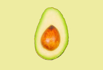 Avocado levitate in air on green pastel background. Concept of vegetable levitation.