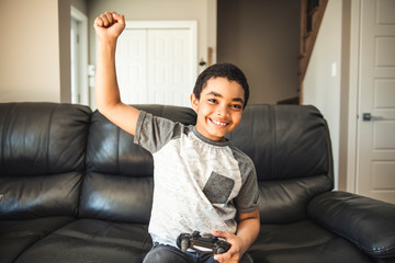 Fototapeta premium Young boy playing video game, at home.