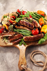 Assorted delicious grilled meat with vegetable on a barbecue. Grilled pork shish or kebab on skewers with vegetables . Food background shashlik