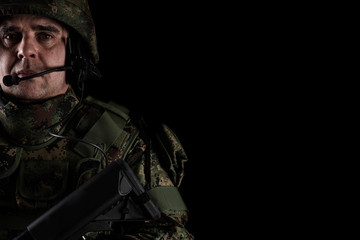 Soldier special forces with rifle on dark background 