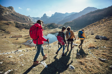 Group of hikers walking on a mountain at autumn day