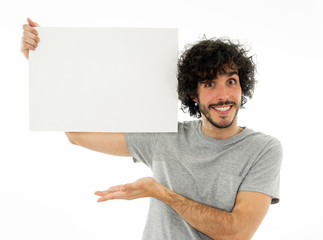 Young funny man holding blank board for advertisement. Millennial men pointing at white billboard