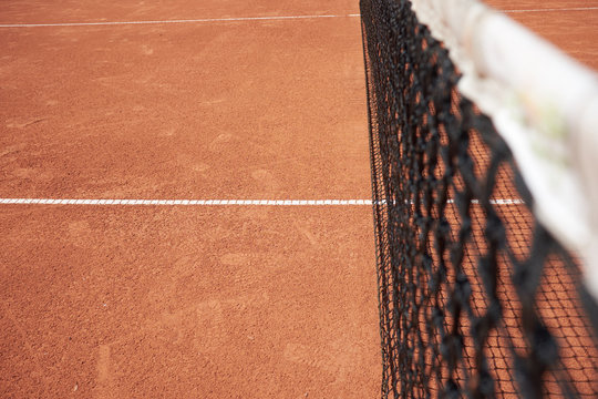 Tennis Net On Red Sand Field