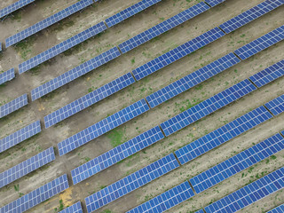 Aerial view of a solar farm producing clean renewable sun energy, industrial landscape