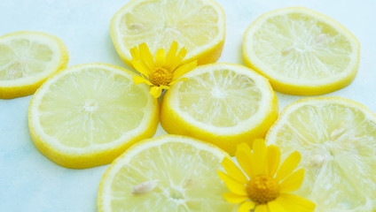 Fototapeta na wymiar Yellow organic lemon slices shows fresh citrus fruit close up, light and airy fruit.
