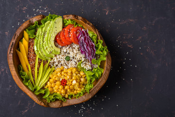 Buddha bowl with chickpea, avocado, wild rice, quinoa seeds, bell pepper, tomatoes, greens,...