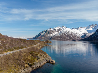 Naklejka na ściany i meble Road along fjord and mountain with snow cap in Norway