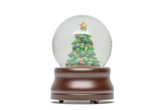 Snow Globe Of Green Christmas Tree With Glittery Sparkles Visible - Brown Wood Base -  Isolated On White