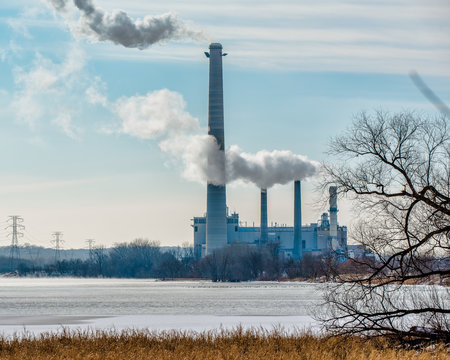 Coal power plant with gases and pollutants coming out of smoke stacks - off the Minnesota River and major bird migration route