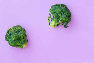 Fresh green broccoli on pink background