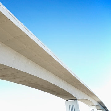 Concrete overpass against blue sky