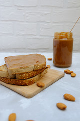 Almond butter toasts on neutral background. Image with copy space, selective focus