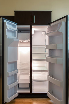 Open empty refrigerator in modern kitchen
