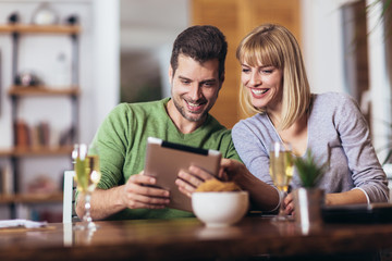 Young couple shopping on internet with tablet