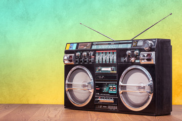 Retro boombox ghetto blaster outdated portable radio receiver with cassette recorder from 80s front gradient colored wall background. Rap, Hip Hop, R&B music concept. Vintage old style filtered photo