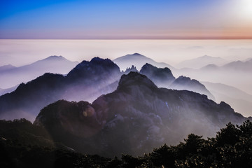 Fog rolling over rocky mountains, Huangshan, Anhui, China