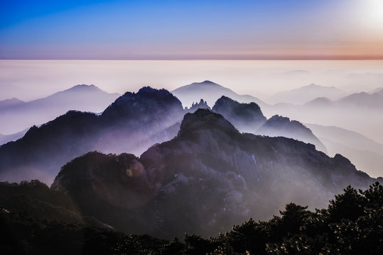Fog rolling over rocky mountains, Huangshan, Anhui, China