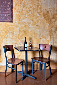 Bottle of wine and glasses on table in wine bar