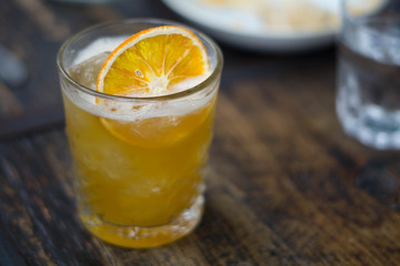 old-fashioned whiskey with orange garnish