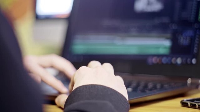 Man look at screen while editing a short movie