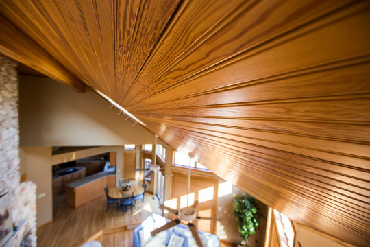 Slanted wood ceiling over living room and dining room