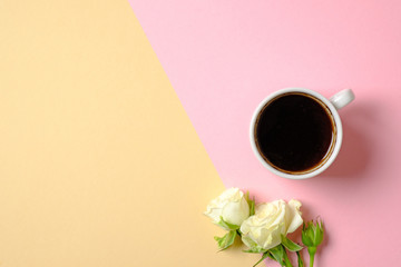 Mug of coffee and bouquet of roses flowers on pastel background. Top view, overheat. Flat lay style composition, creative layout. Concept of love, tenderness, morning breakfast, dating, freshness.