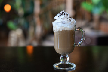 Aromatic Latte Irish Coffee with Frothy Cream in a Glass on a Bar in a Restaurant