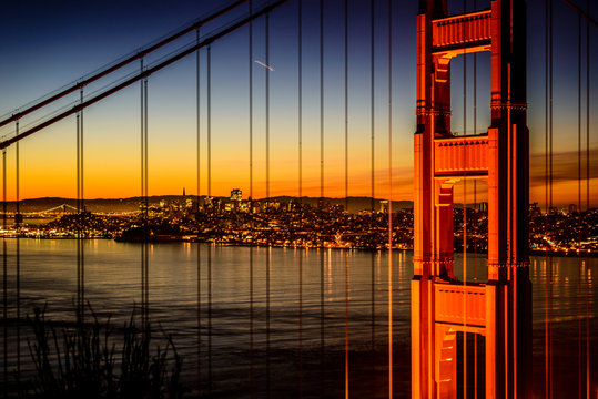Golden Gate Bridge and San Francisco skyline lit up at night, San Francisco, California, United States