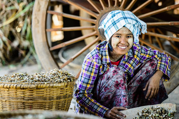 Asian girl selling herbs in market