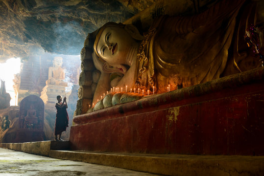 Monk lighting incense in temple