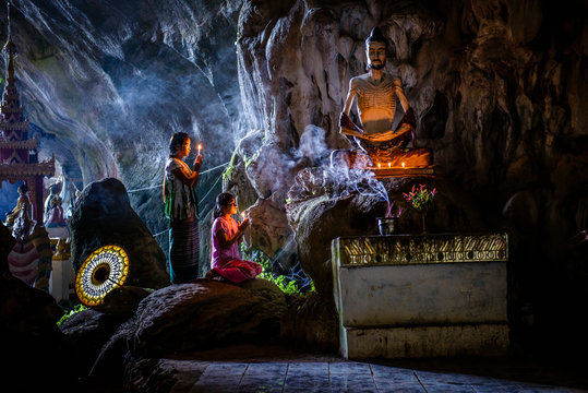 Asian girls lighting incense in temple