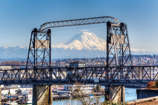 Snowy mountain viewed through urban bridge, Tacoma, Washington, United States