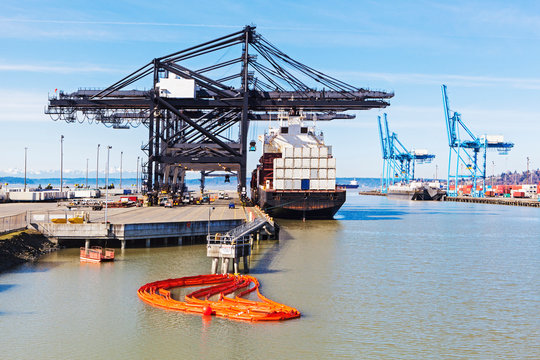 Cranes over cargo ship in harbor