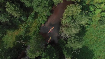 Aerial view over kayaking group of people in the middle of Lithuania most popular river Ula in Dzukija National Park. During summer season.