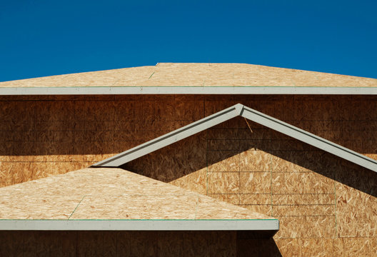 Low angle view of chip board walls of house under construction