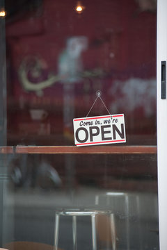 Close up of open sign on cafe door
