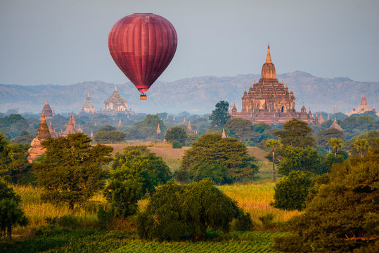 Hot air balloon flying over towers