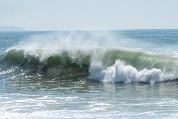 wave on beach in sunny calm day, Nazare, Portugal