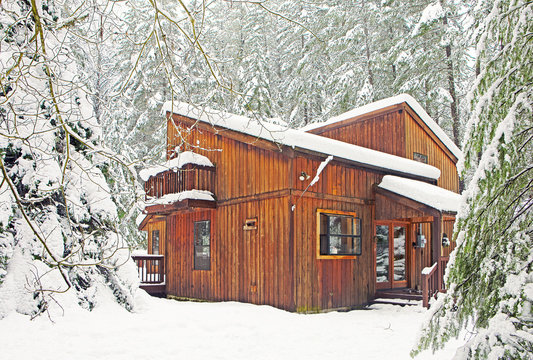 Modern Wood Cabin In Snowy Forest