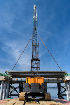 Low angle view of crane and bridge construction